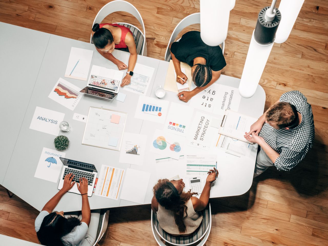 about-img Diverse team collaborating on marketing strategy in a modern office setting.